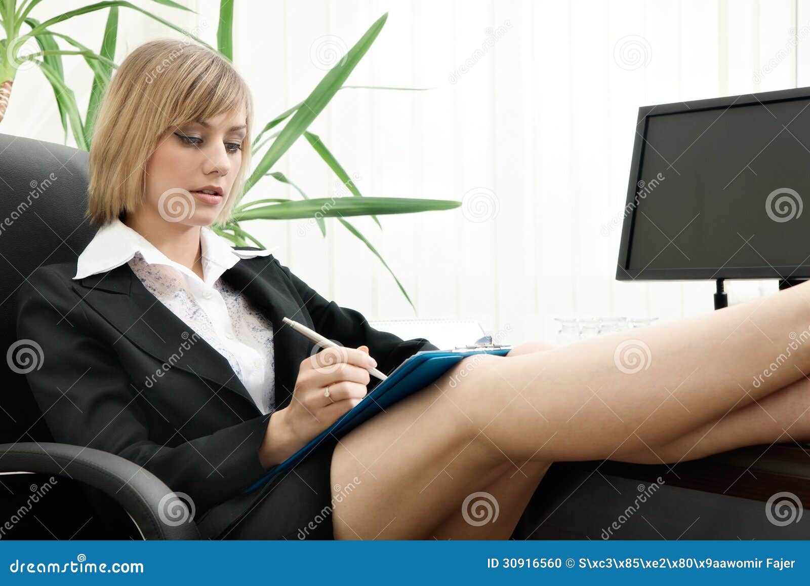 businesswoman sitting feet up desk focus face 30916560