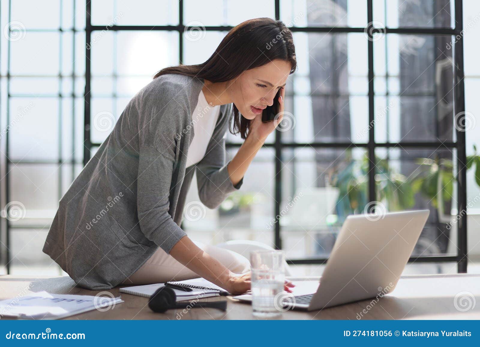 businesswoman with phone in modern office talking