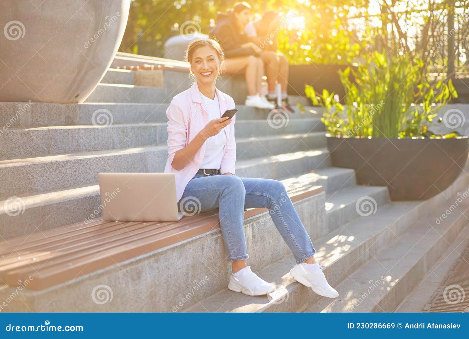 businesswoman sitting stairs summer park using laptop business persone working remote. outdoor