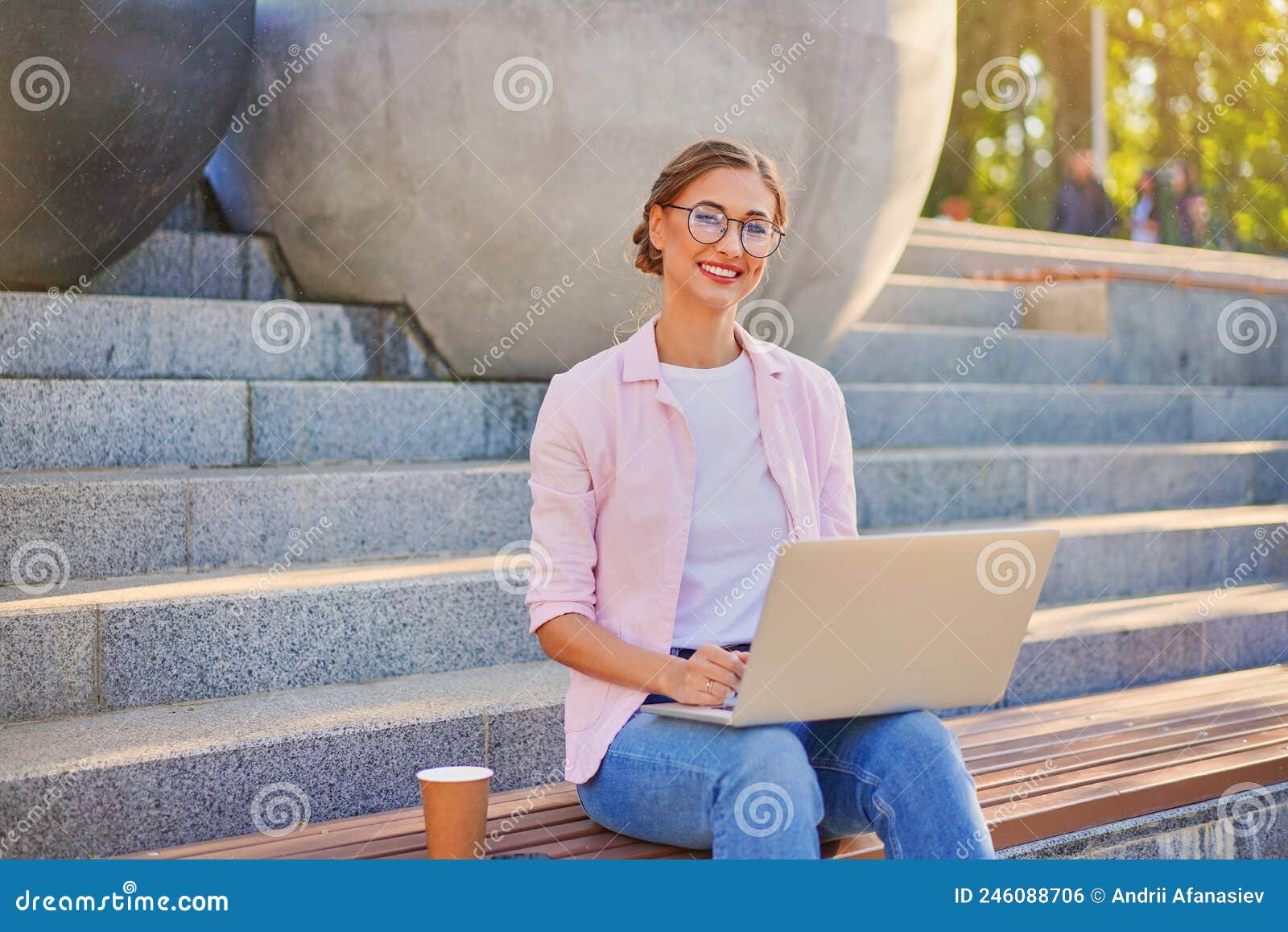 businesswoman sitting stairs summer park using laptop business persone working remote. outdoor