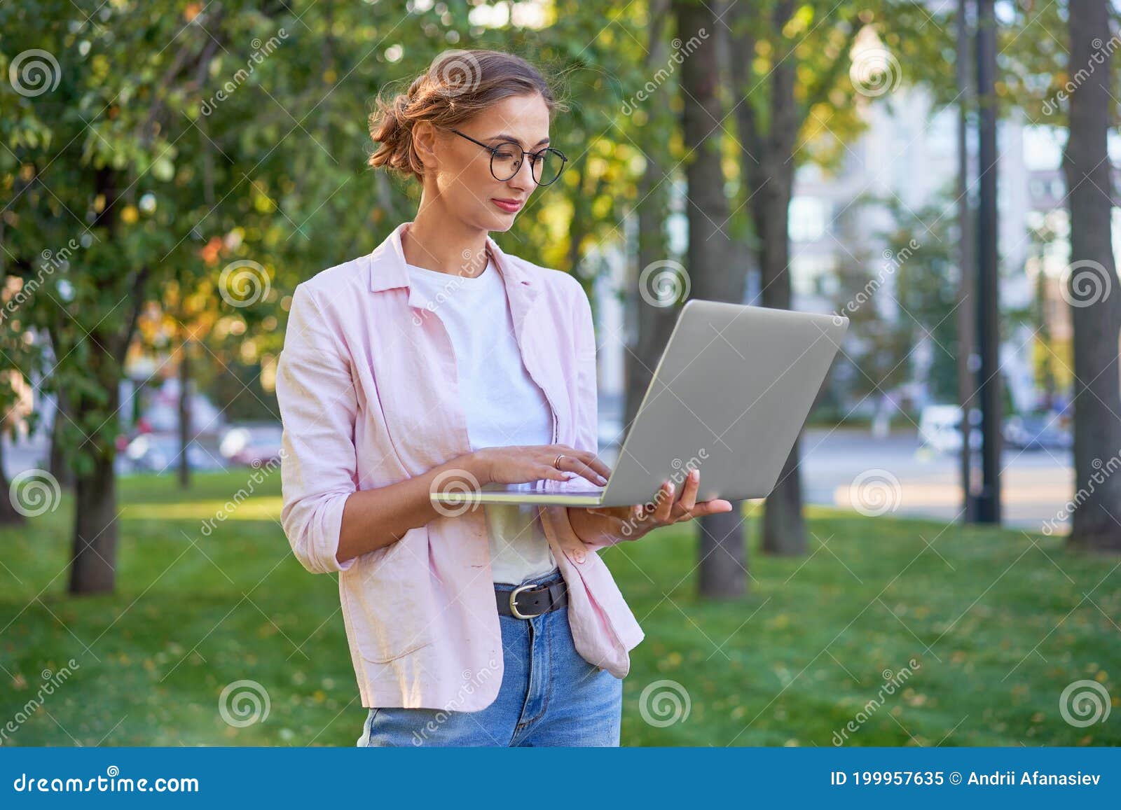 businesswoman standing summer park using laptop business persone working remote. outdoor