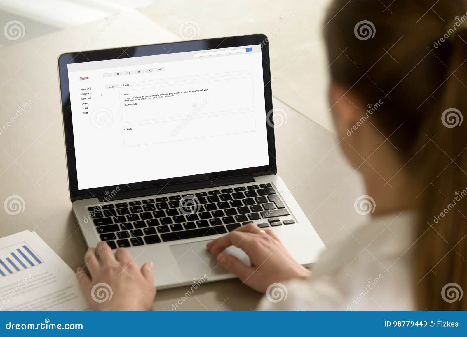 businesswoman typing corporate e-mail using laptop at office des