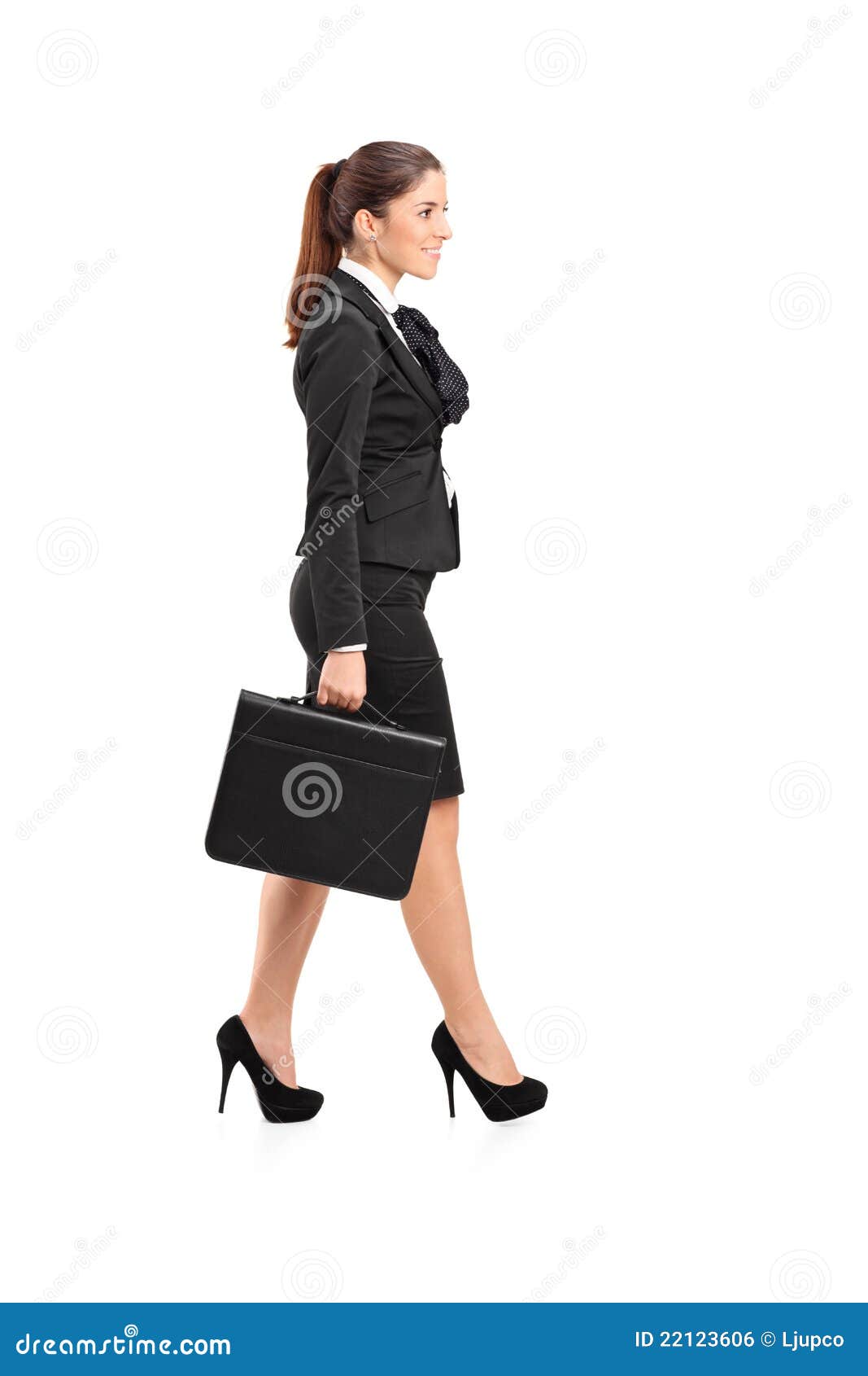 Businesswoman Walking with a Briefcase in Her Hand Stock Photo Image