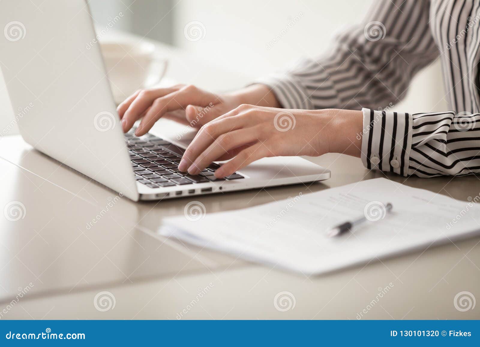 businesswoman working on laptop, female hands typing on keyboard
