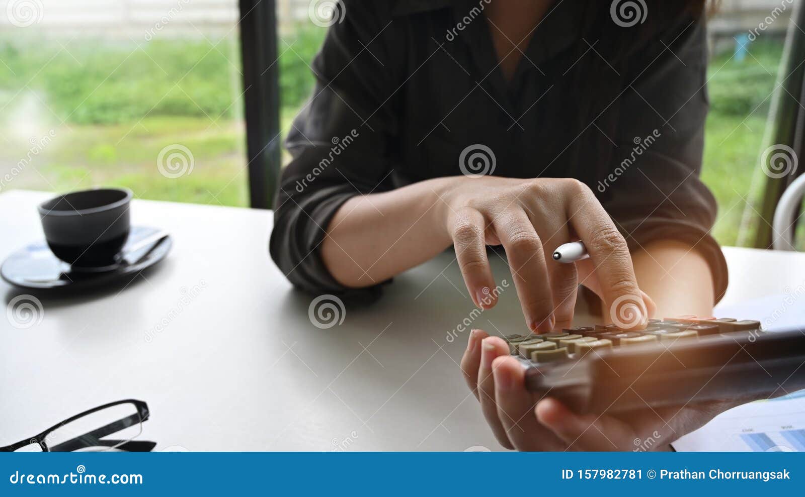 .businesswoman working and using calculator calculate budged money.
