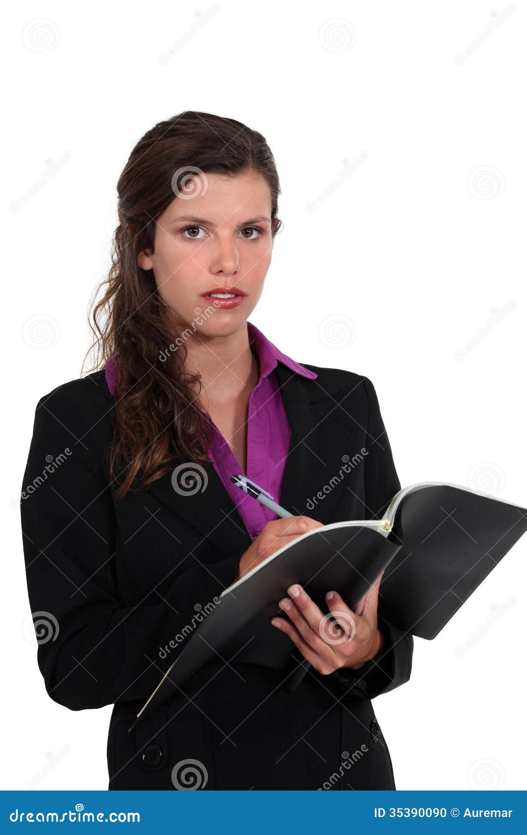 Businesswoman writing in a pad. Businesswoman writing something in a pad