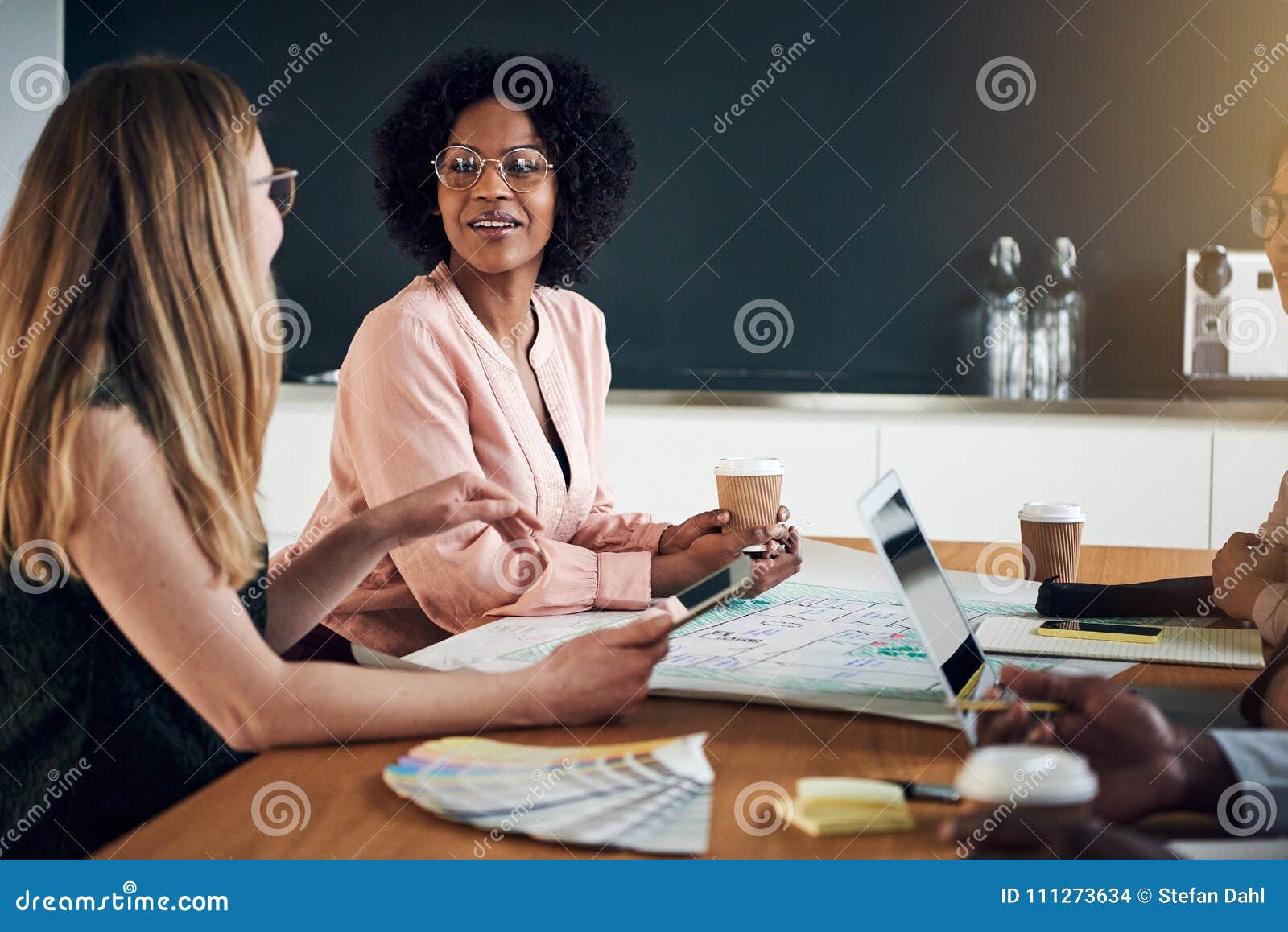 businesswomen talking together during a meeting in an office boa