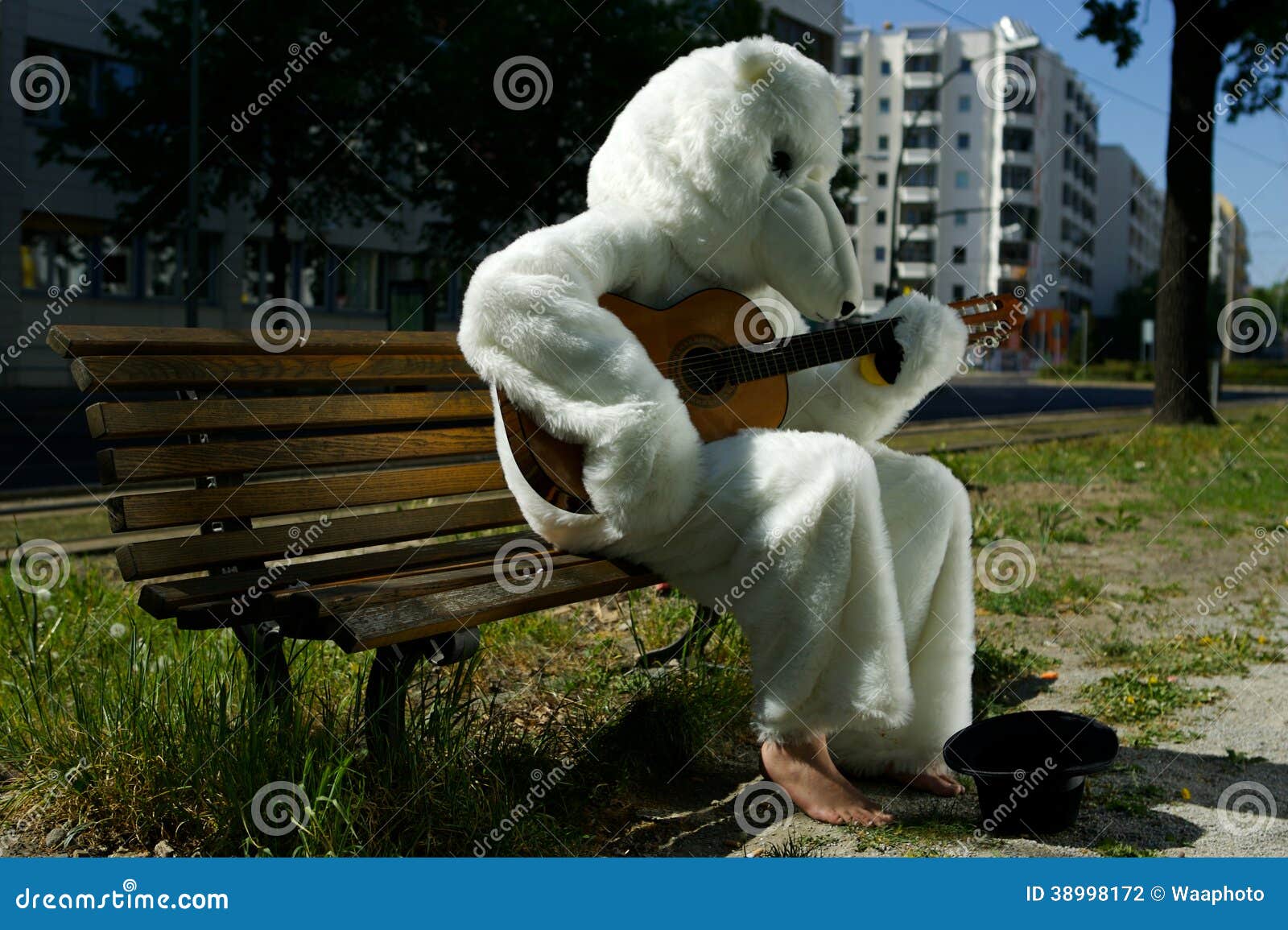 busker street performer in bear suit playing guitar