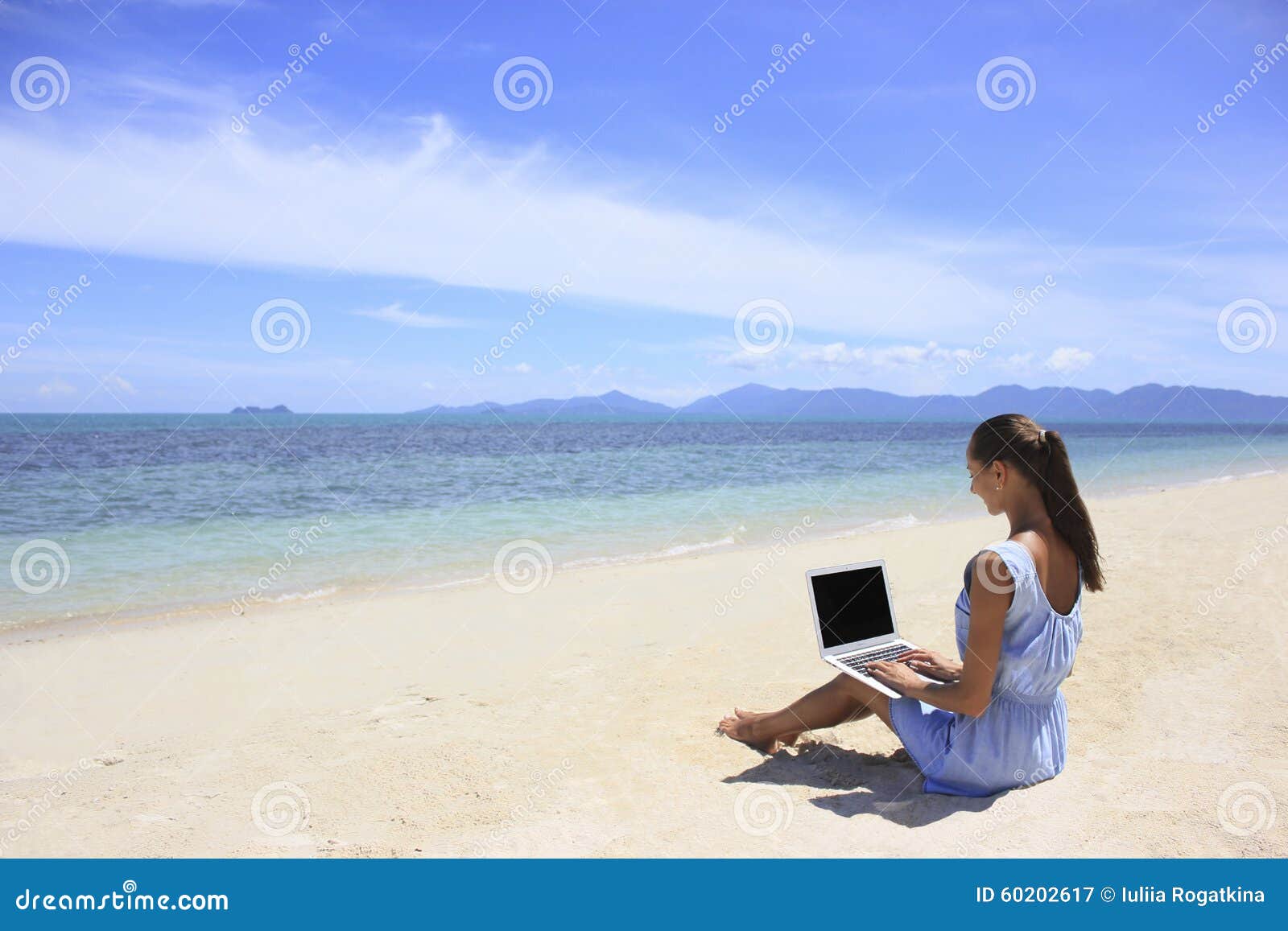 bussines woman working on the beach with a laptop