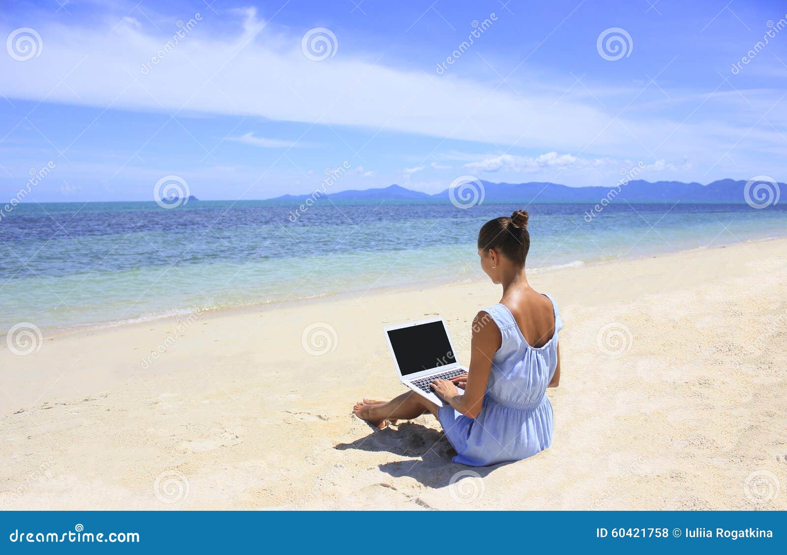 bussines woman working on the beach with a laptop