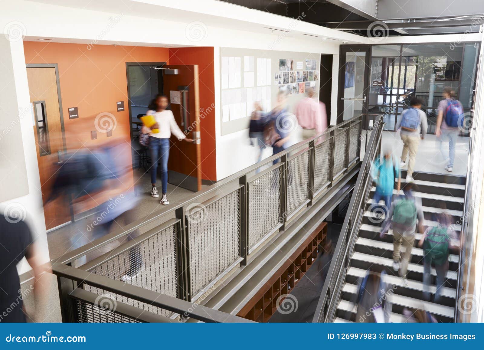 Busy High School Corridor during Recess with Blurred Students and Staff