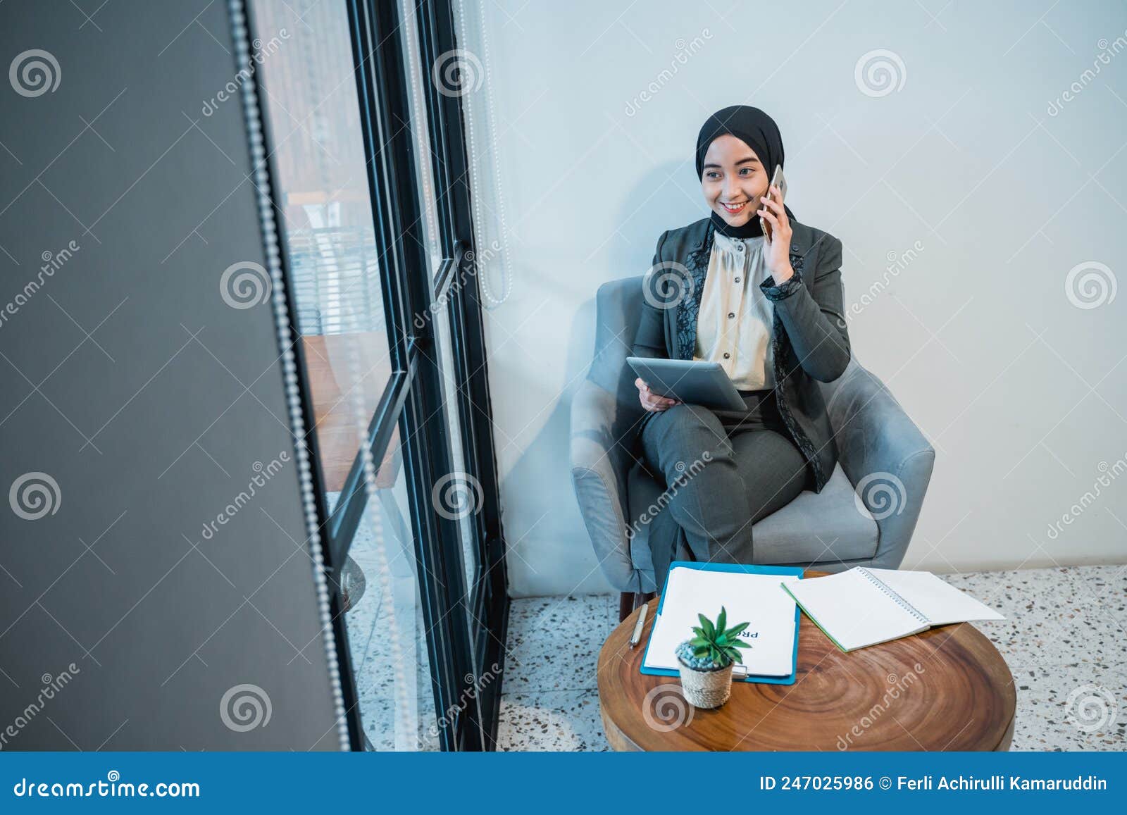 Muslim Businesswoman Making a Phone Call while Working in the Office ...