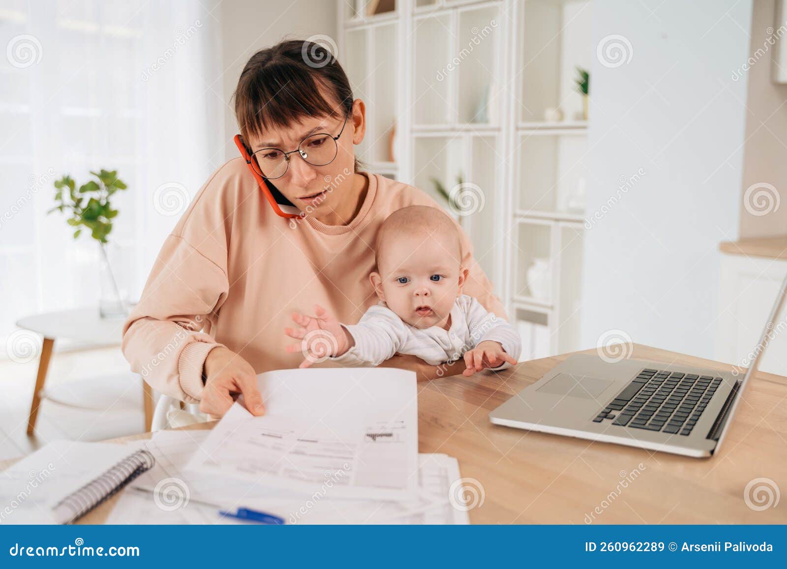 stressed upset mother trying to work from home with little child