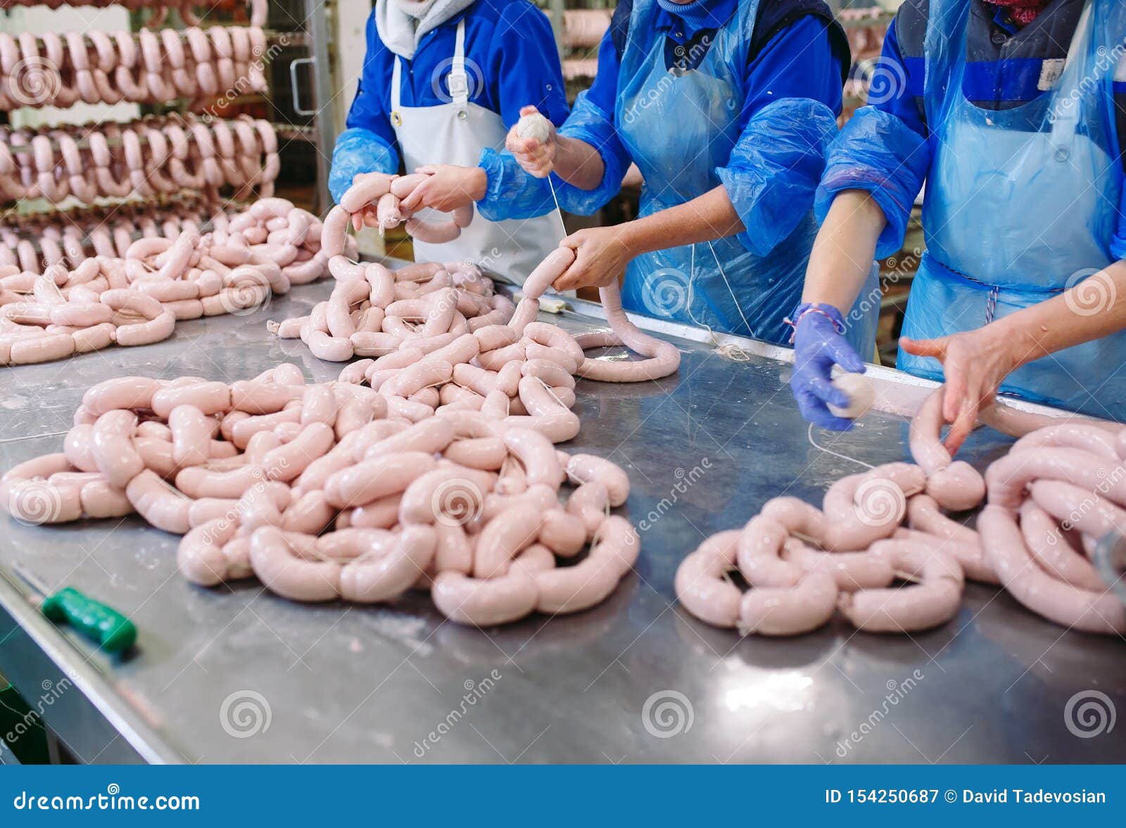 Butchers Processing Sausages at a Meat Factory. Stock Image Image of