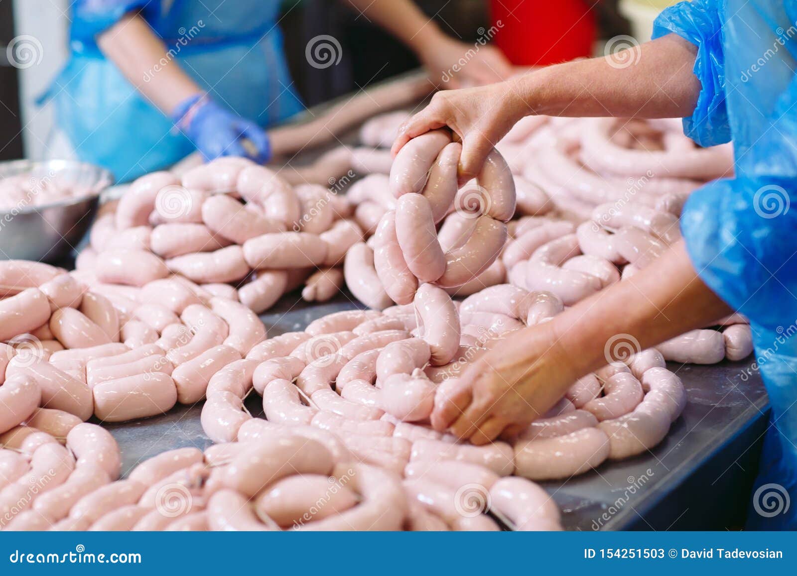 Butchers Processing Sausages at a Meat Factory. Stock Image Image of