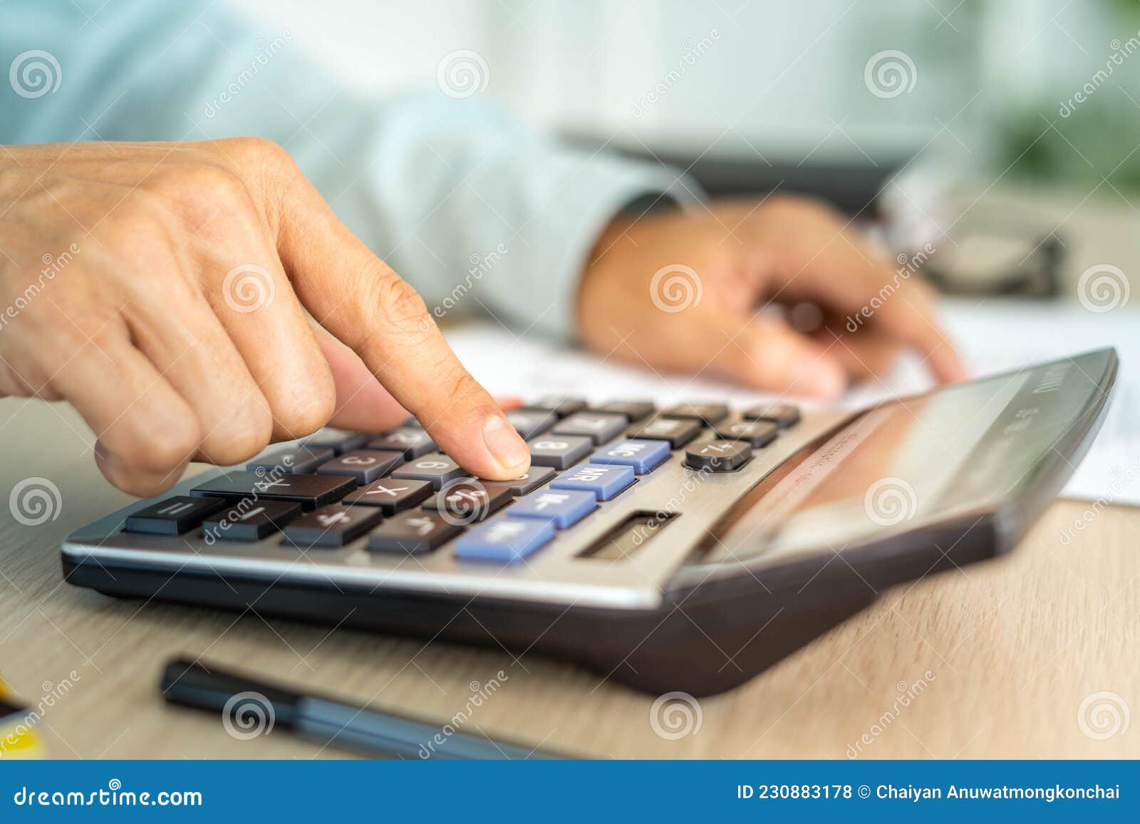 the-butler-is-pressing-the-calculator-calculate-the-various-costs-that