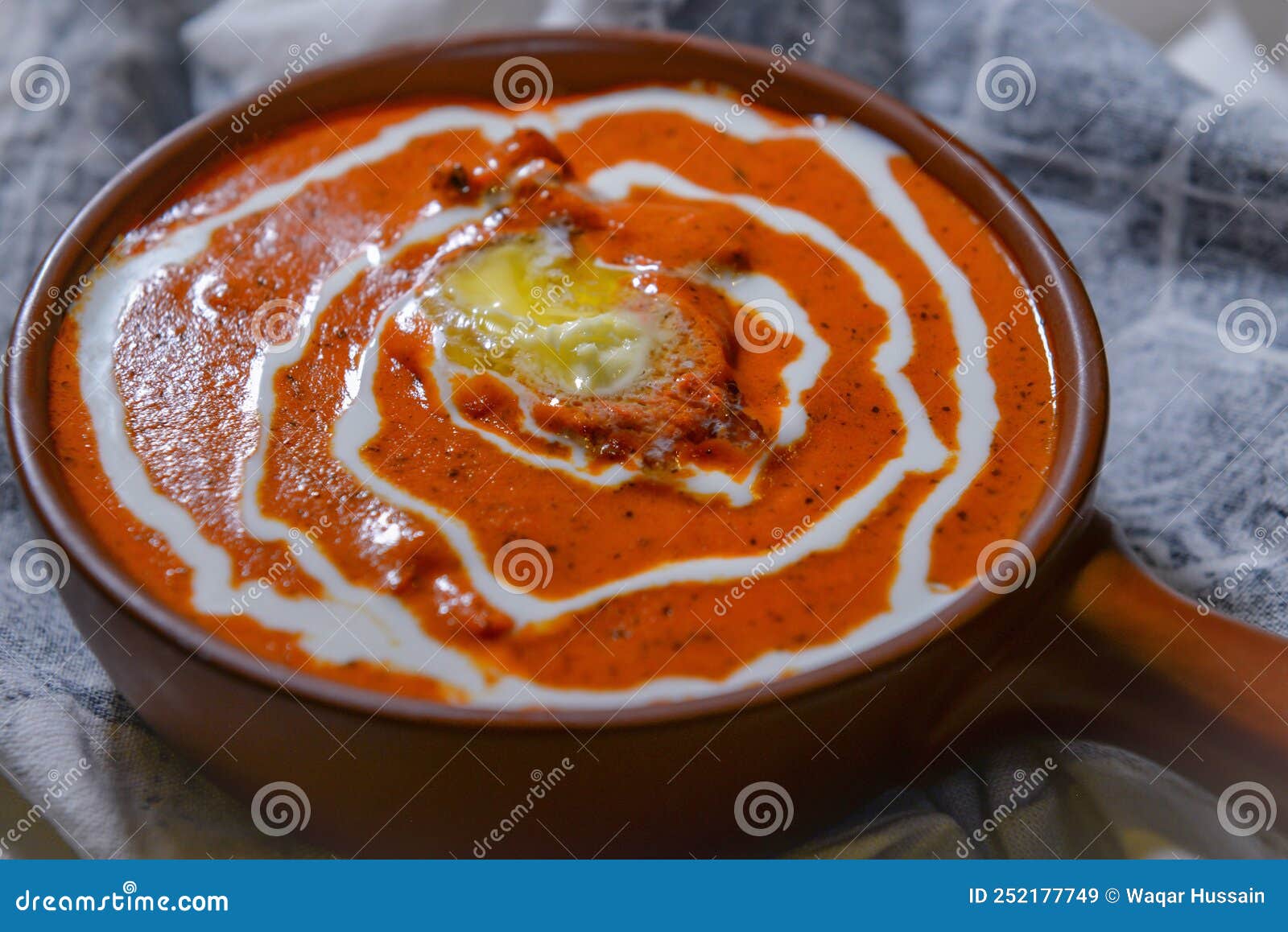 Butter Chicken or Makhni Chicken Served in a Dish Isolated on Dark Background Side View Stock