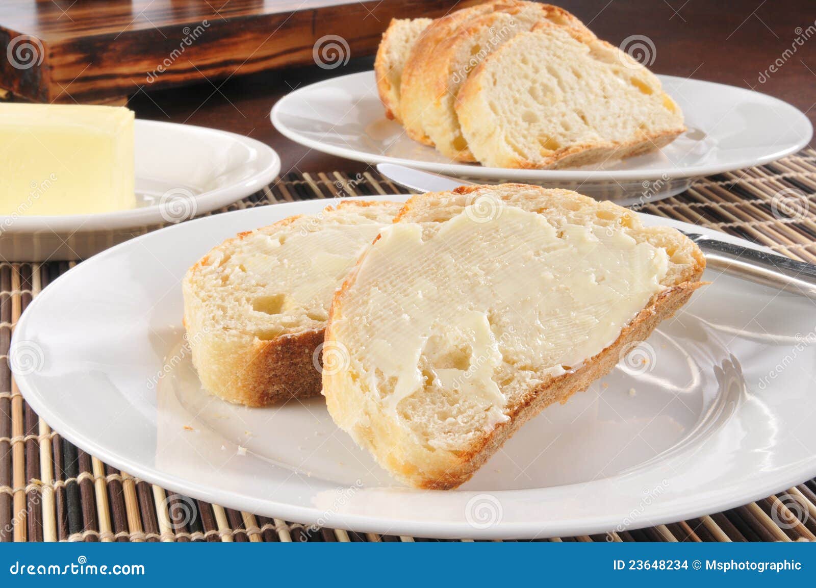 Buttered french bread stock photo. Image of plate, knife 23648234