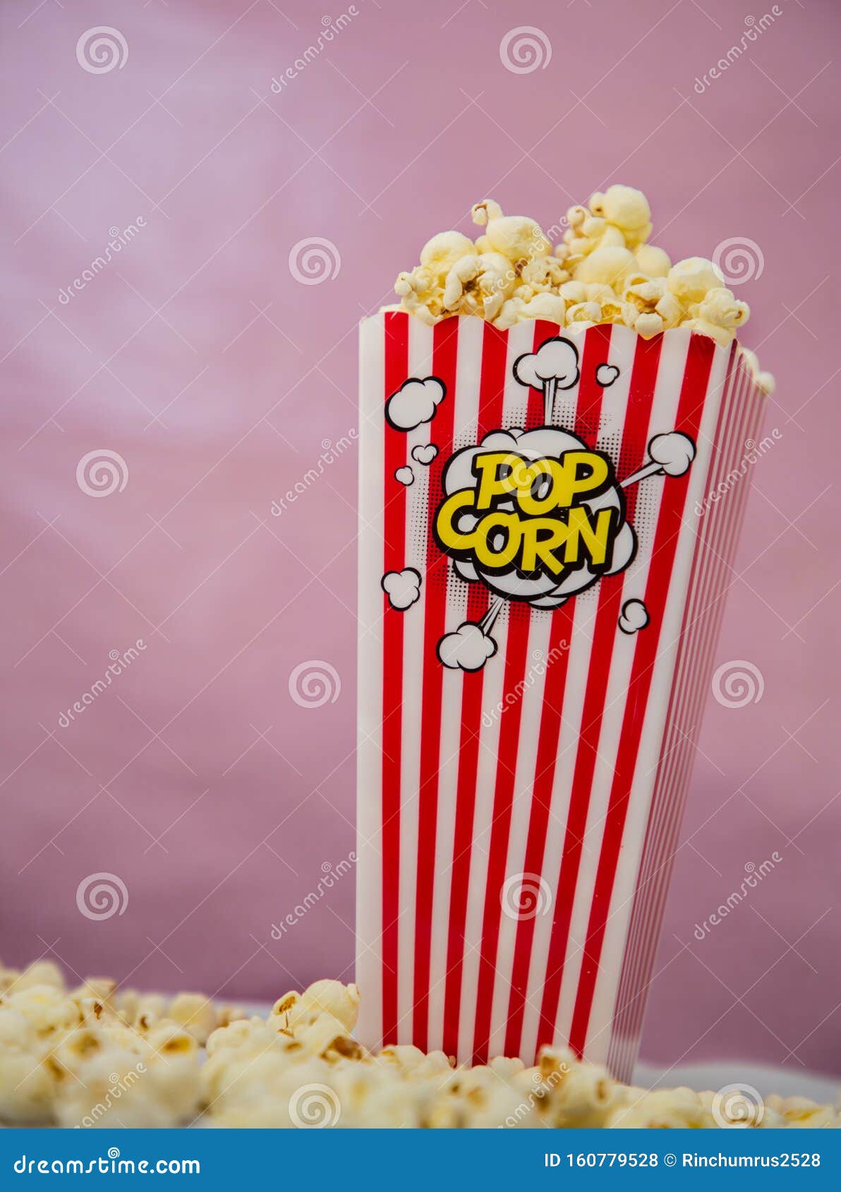 Buttered Movie Popcorn in a Popcorn Cup on Background. Stock Photo