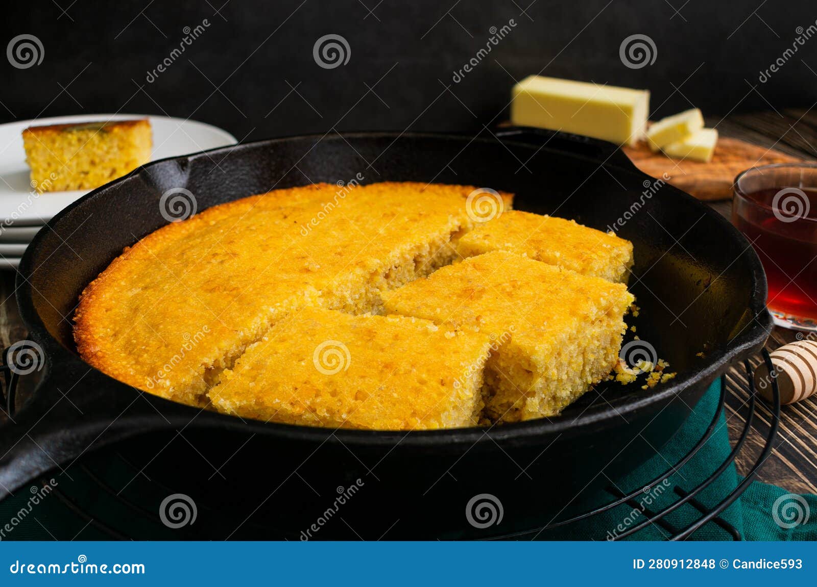 Buttermilk Cornbread Baked Cut into Pieces in a CastIron Skillet Stock