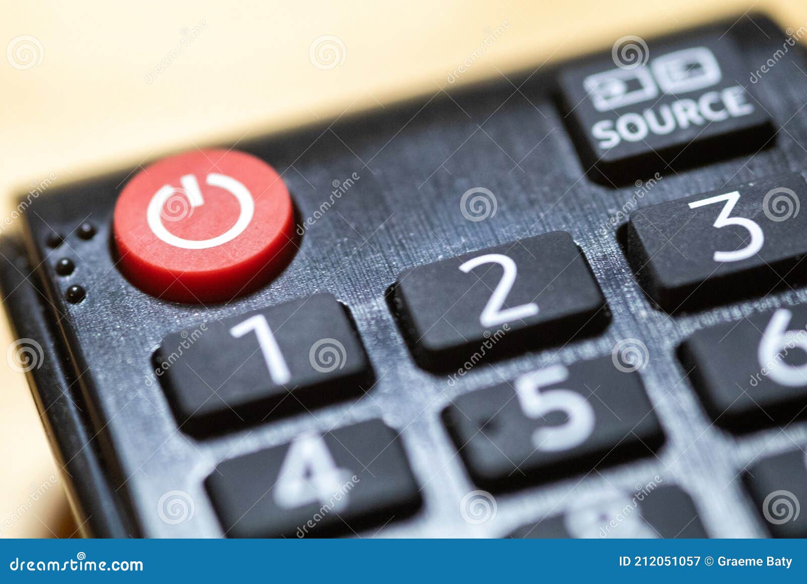 Power Button Closeup on TV Remote Control with Braille and Copy Space