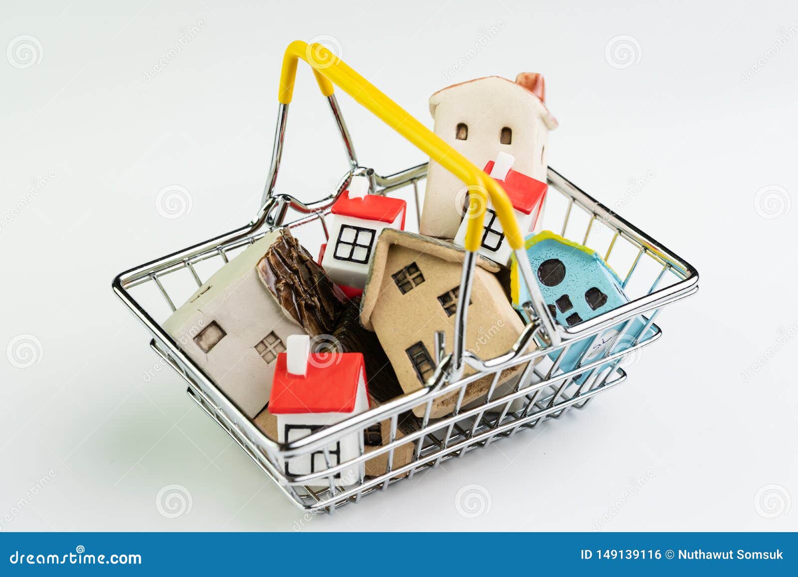 buy and sell house or real estate purchasing concept, shopping basket with full of small cute miniature houses on white background