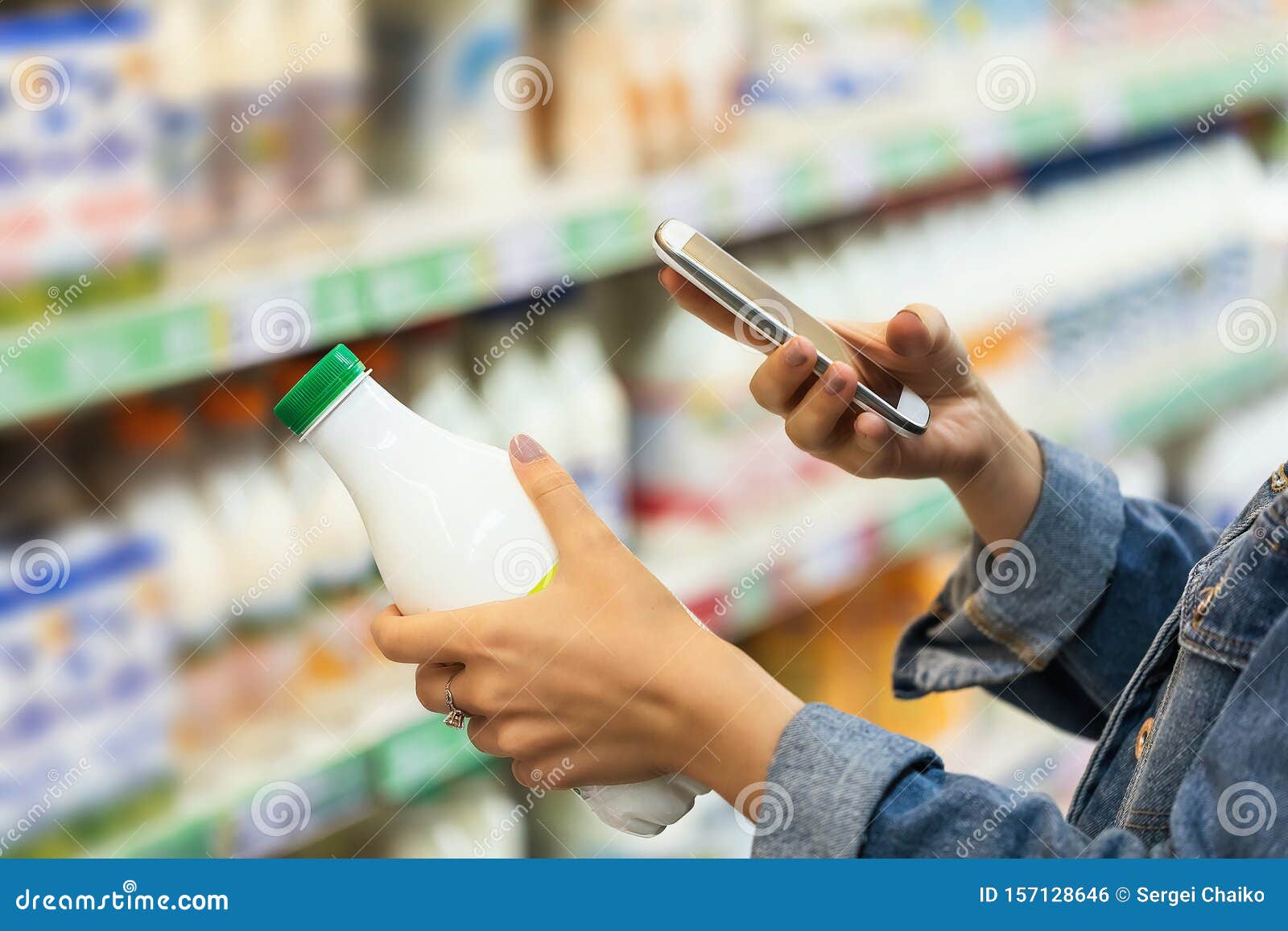 buyer photographs a bottle of milk, a mystery shopper. checking the quality of the goods by barcode