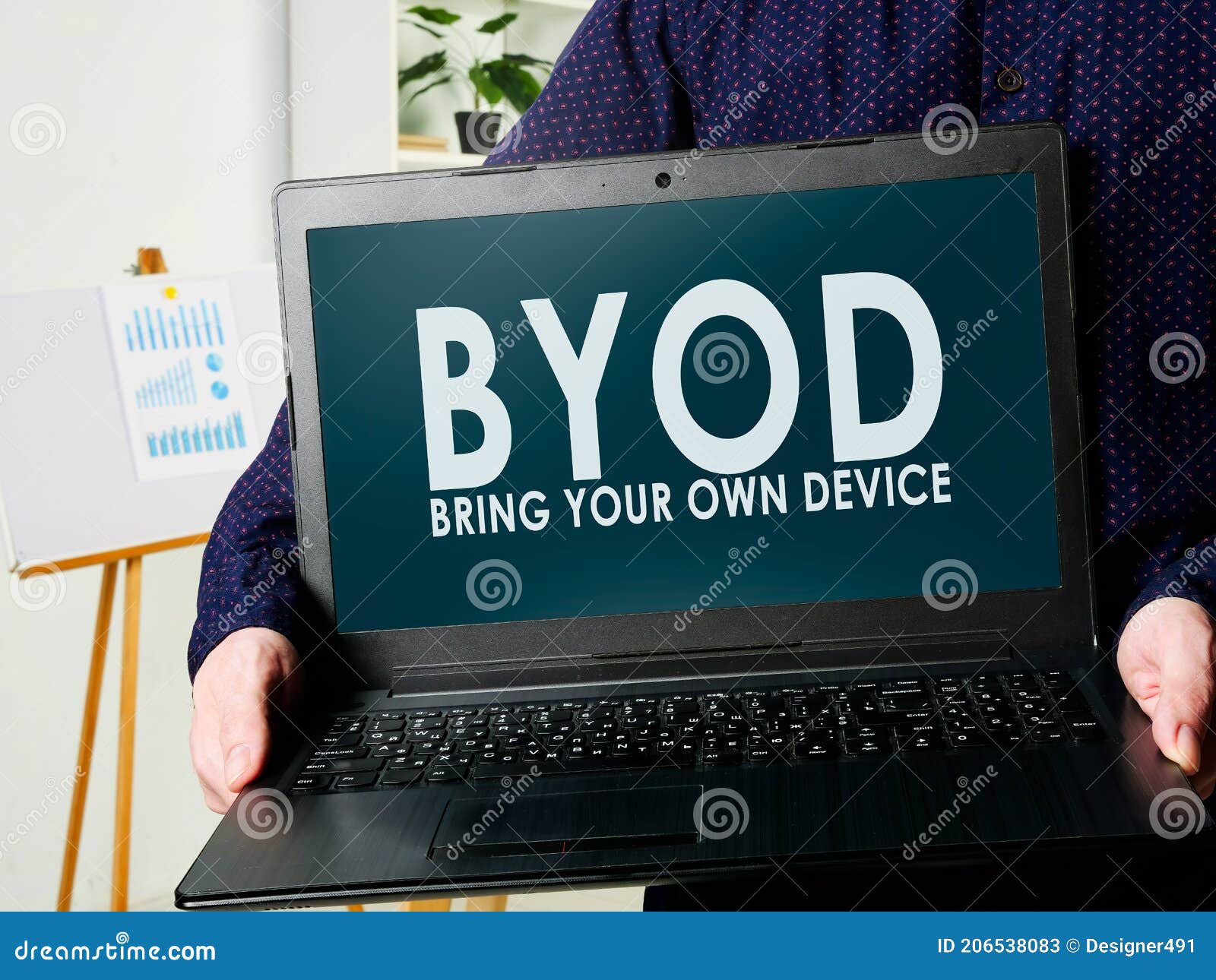 byod bring your own device. man holds a laptop in his hands.
