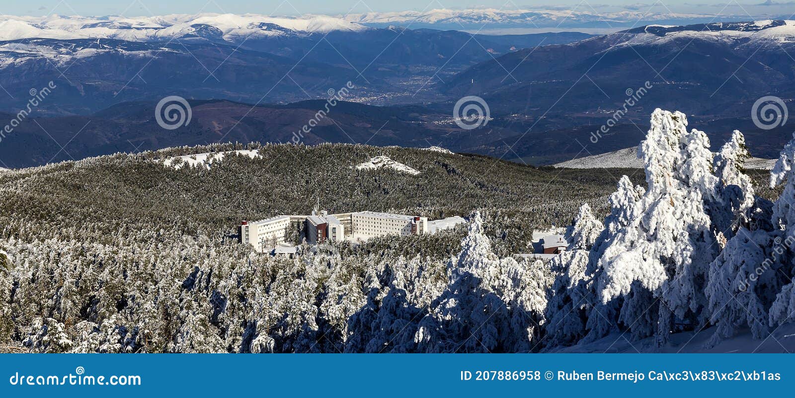 cabeza de manzaneda ski resort covered in snow among pine trees on a sunny day