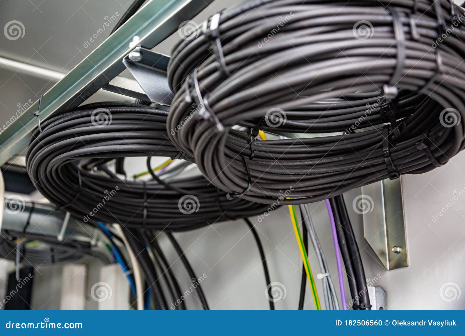 Cable Management. Working Wires, Cables Wound into a Coil, a Circle. Two Rings of Coiled Wires