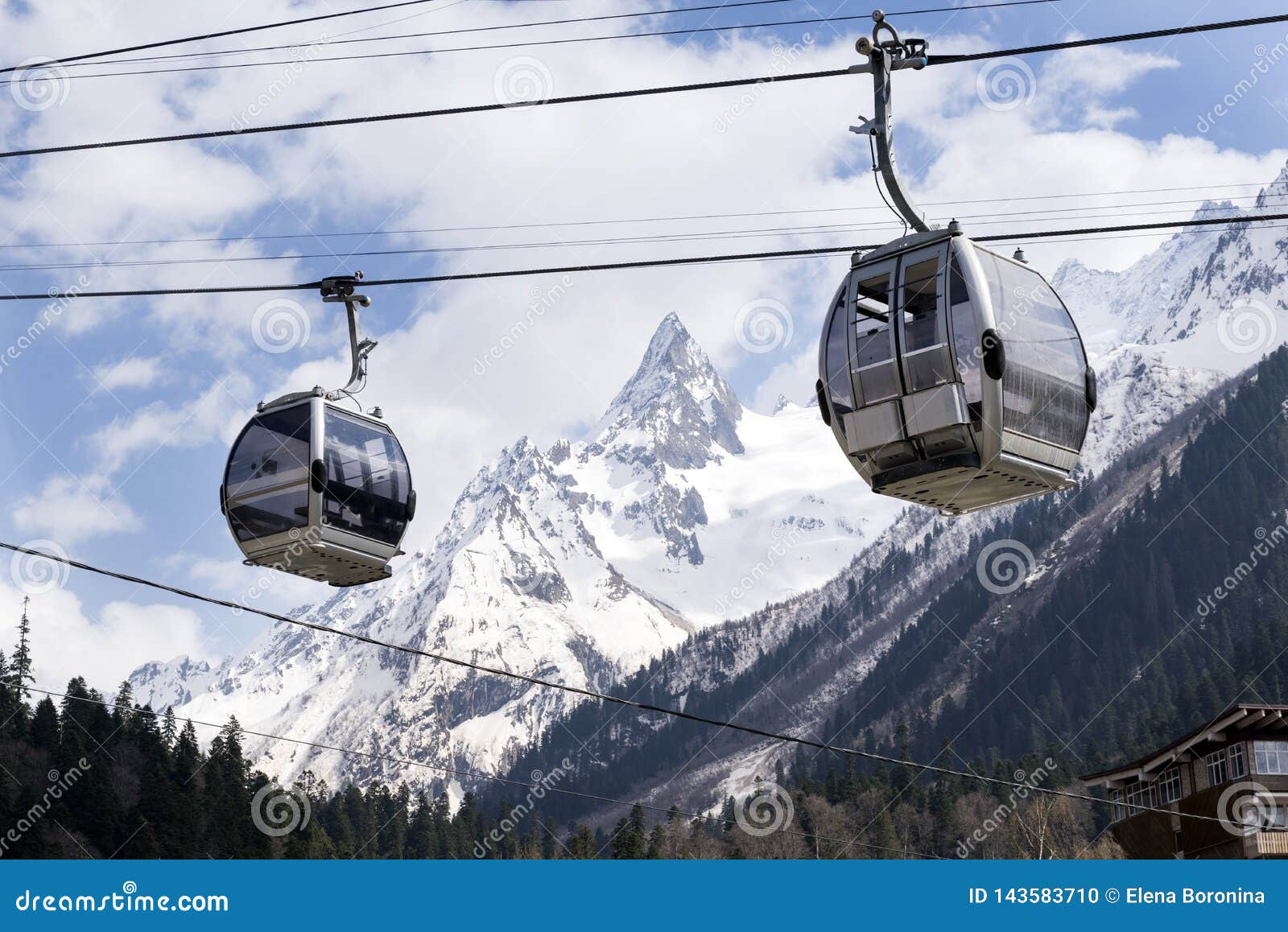 2 Cableways on the Cable Car on the Background of Snowcapped Mountains