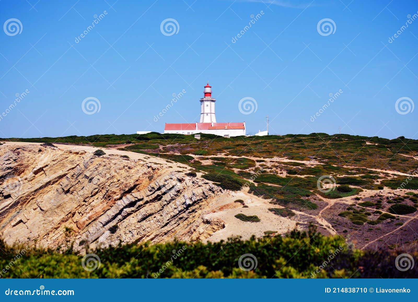 cabo espichel farol. especial cape lighthouse. portugal. landscape. shipping. help. sky. colorful background. blue red green white