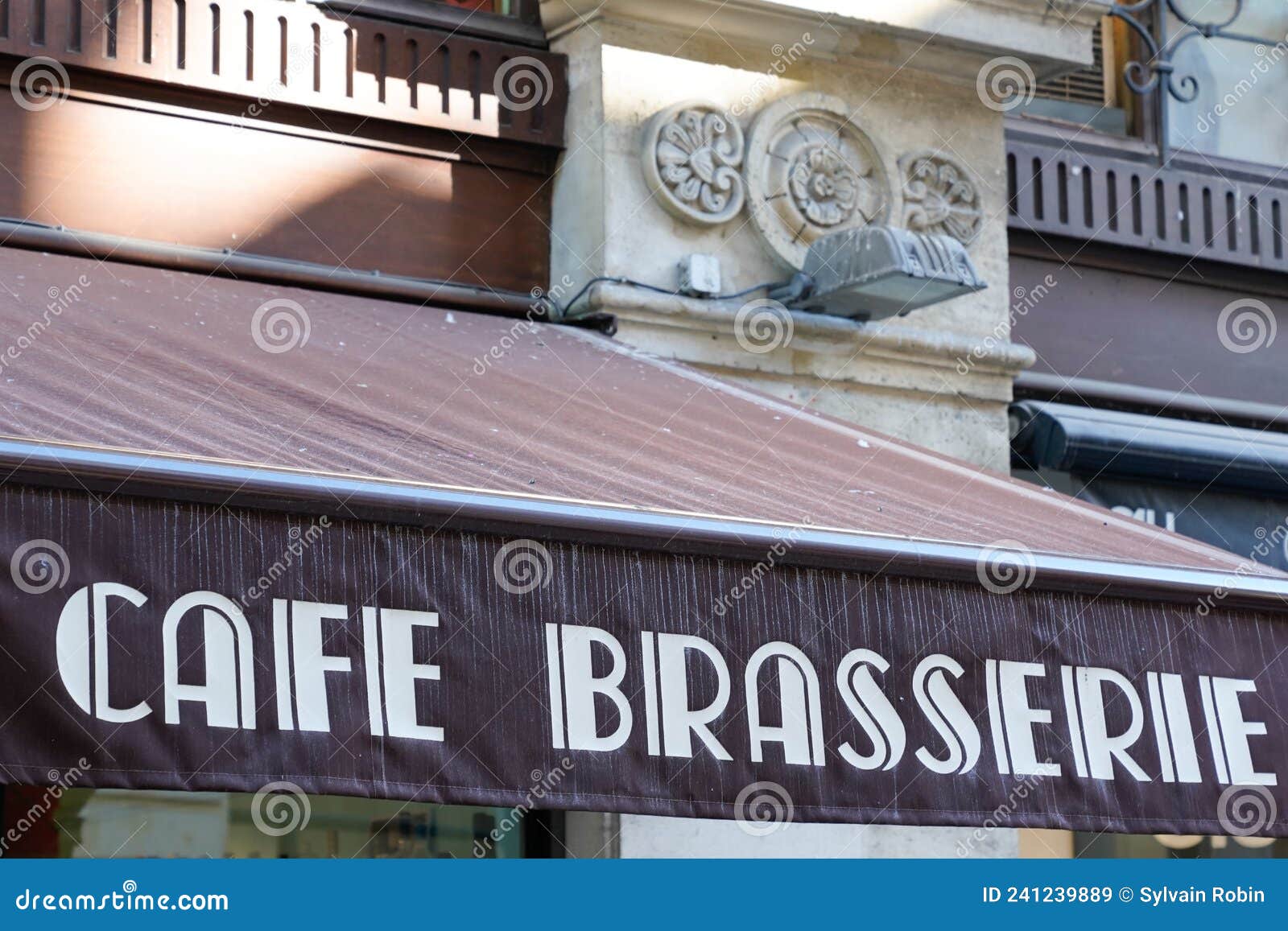 cafe brasserie french sign text means coffee brewery on entrance restaurant in city street storefront building pub entrance
