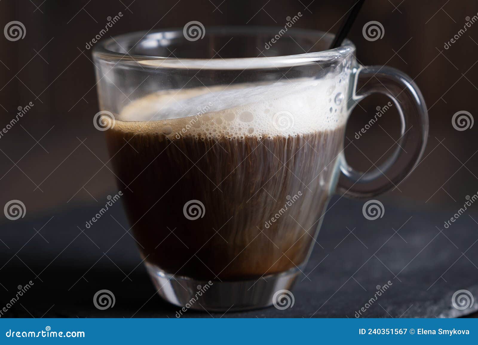 cafe espresso macchiato layered coffee in a see through glass coffee cup