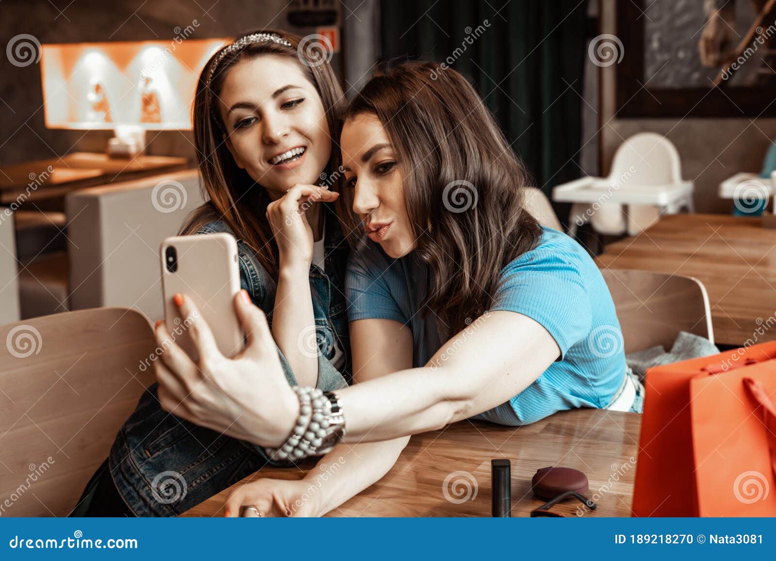 Cafes and Bars. Two Girls are Sitting at a Cafe Table. Discussion of ...