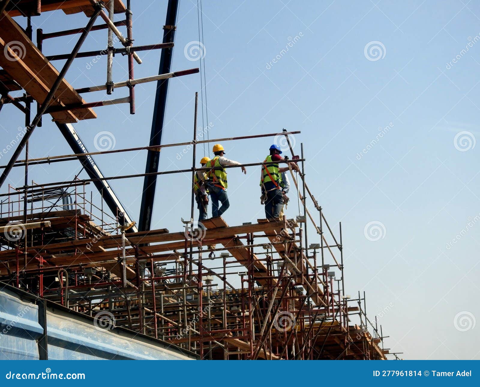 Cairo, Egypt, May 10 2023 Engineers and Workers at a Construction Site with Scaffolds and