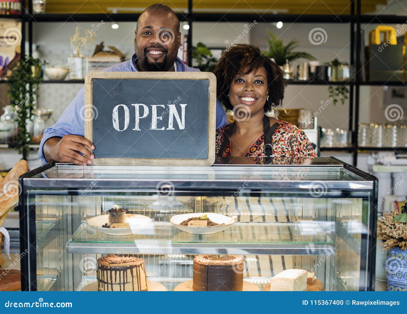 cake cafe owners with open sign