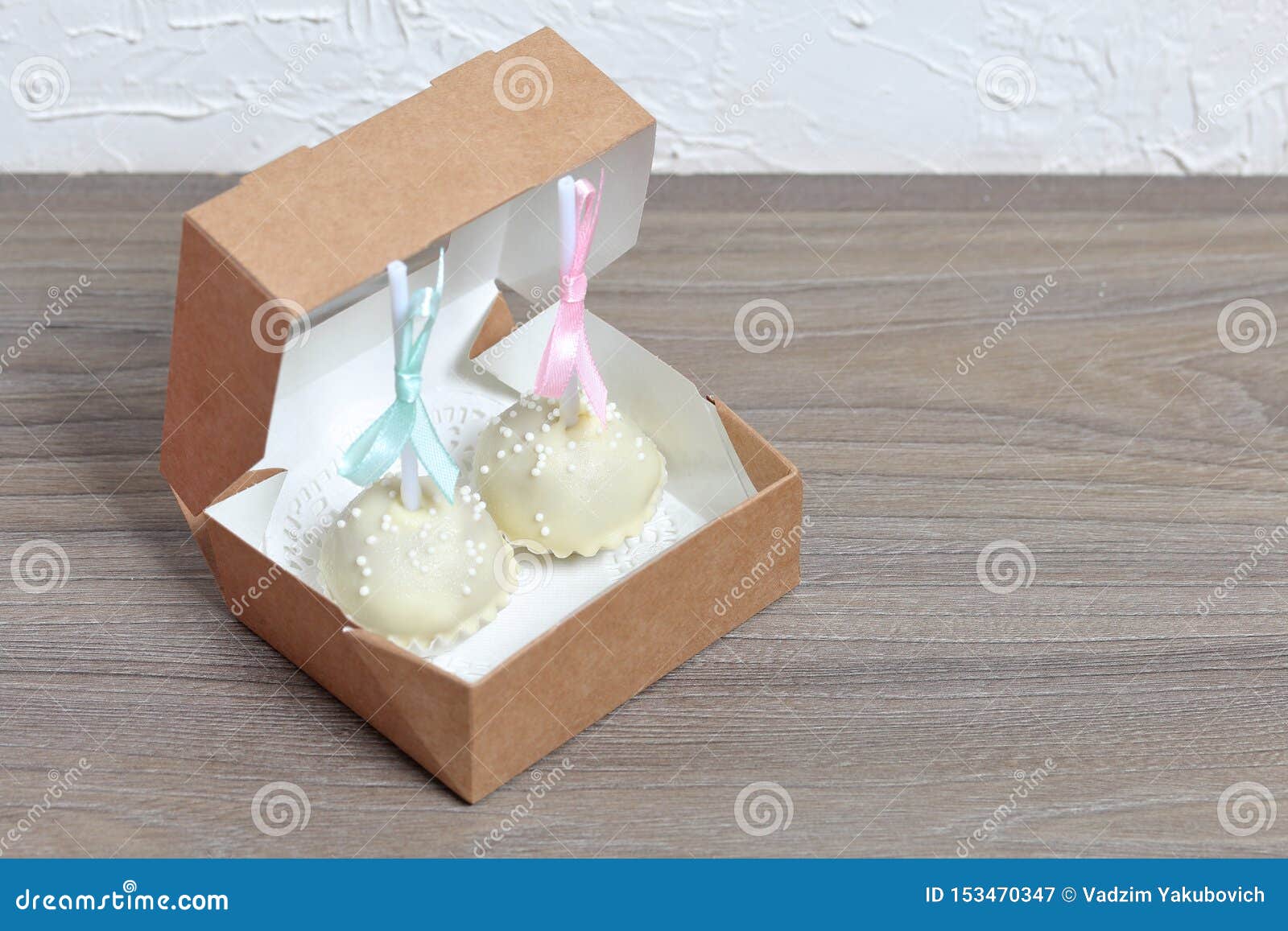 cake pops decorated with a bow of braid, packed in a gift box