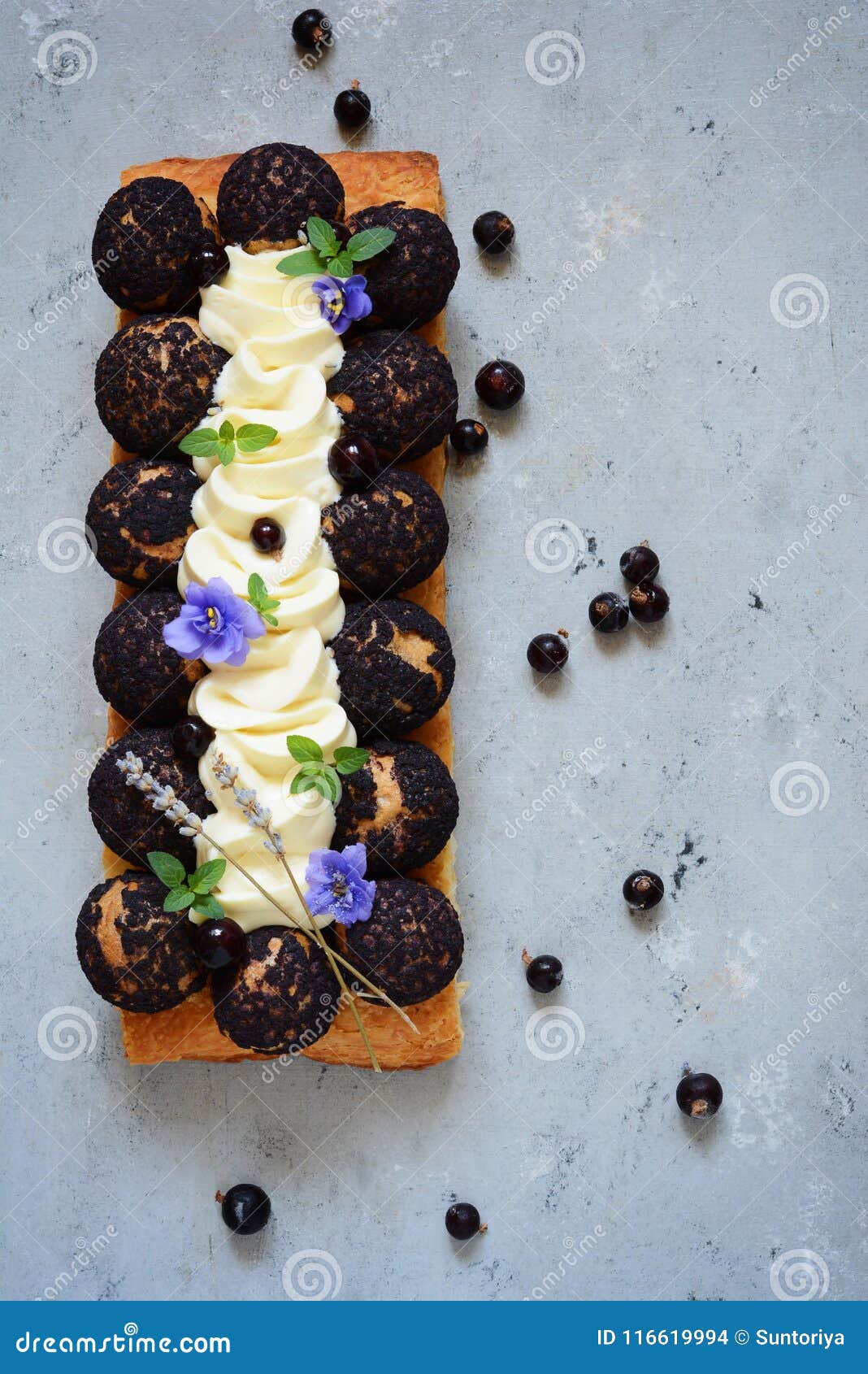 cake of saint-onore from puff pastry, profiteroles, currant cream and whipped cream. classic french dessert. an exquisite confecti