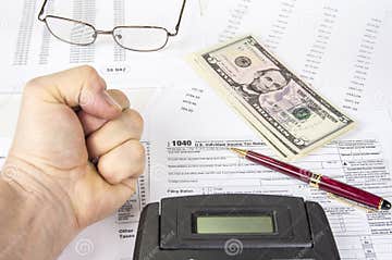 Calculating Numbers For Income Tax Return With Pen Glasses And 