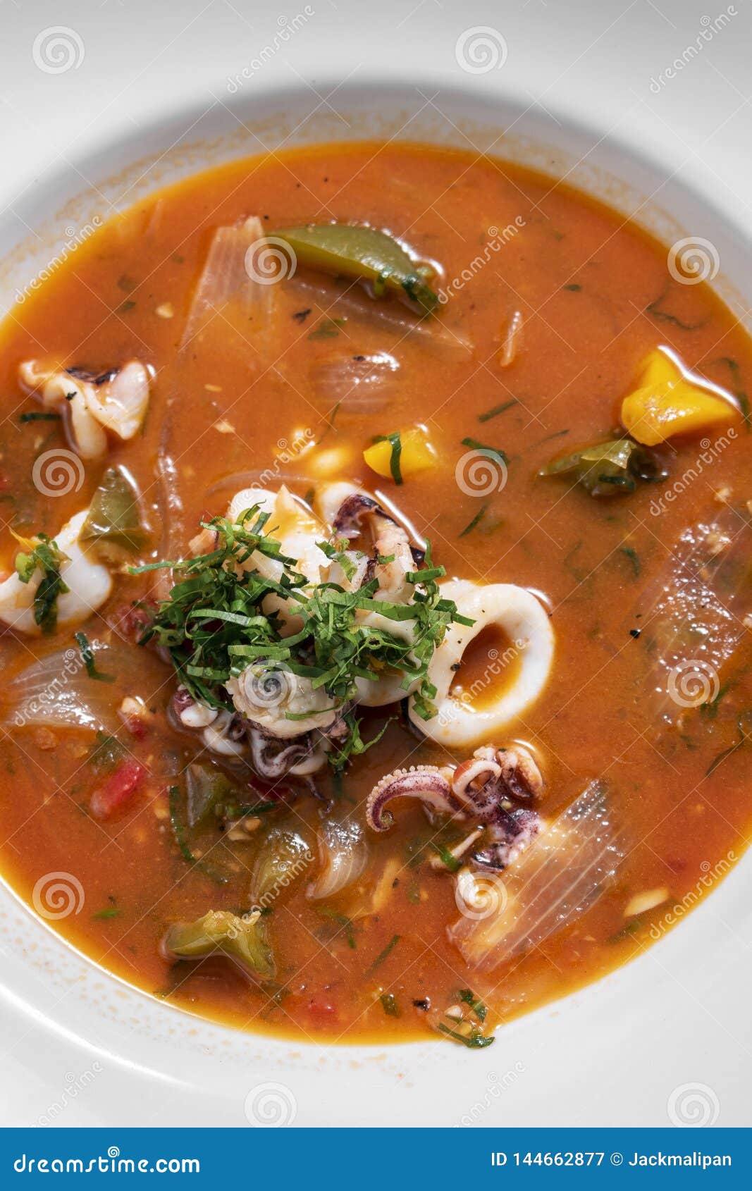 stewed squid seafood soup in spicy tomato and vegetable sauce