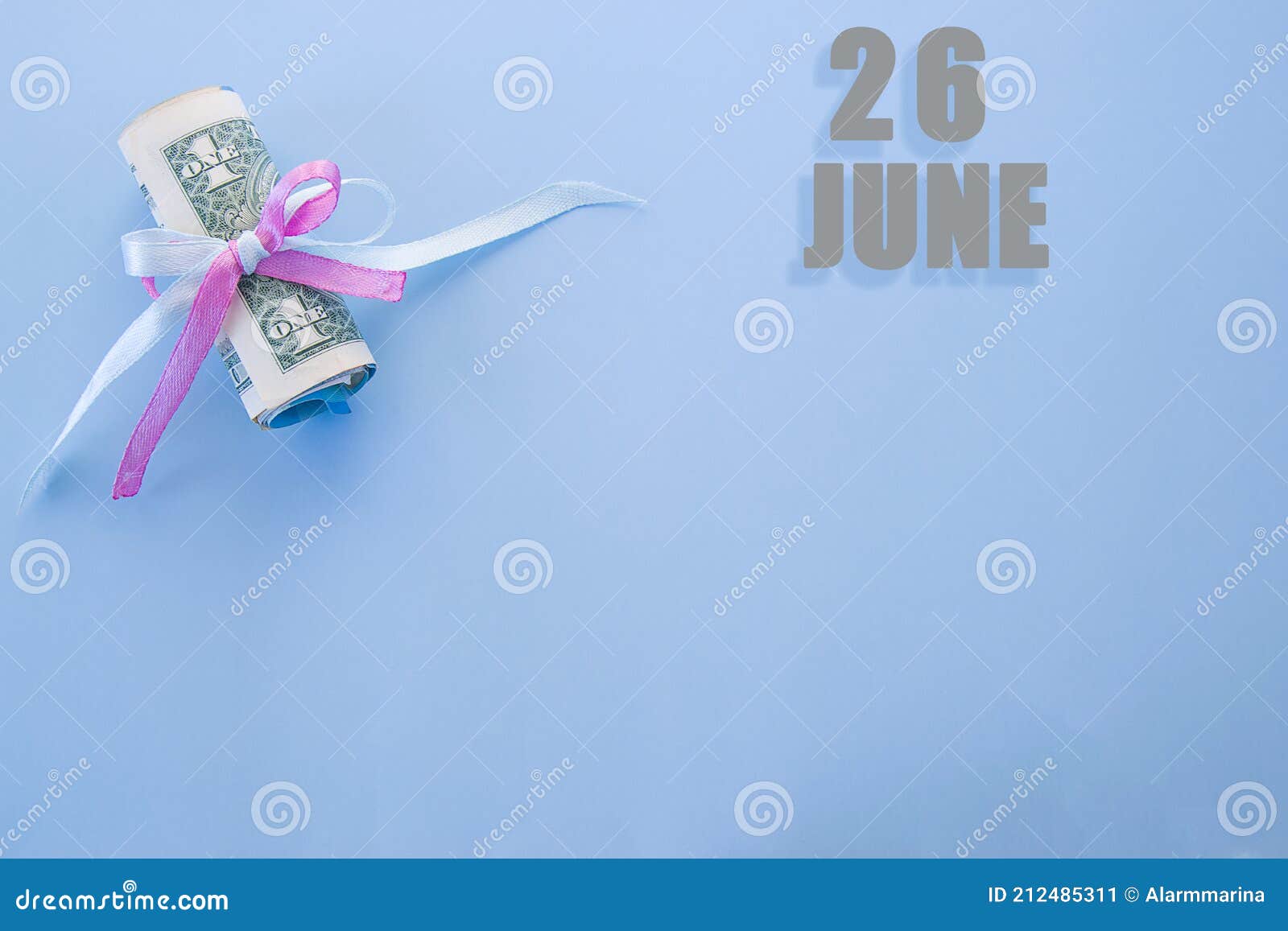 calendar date on blue background with rolled up dollar bills pinned by blue and pink ribbon with copy space. june 26 is the twenty