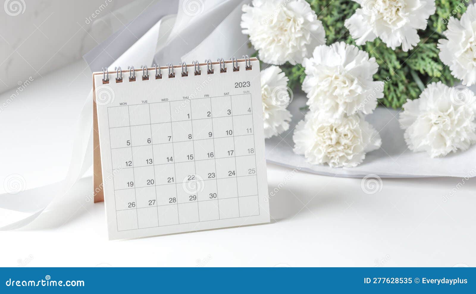 calendar 2023 with flowers on white table