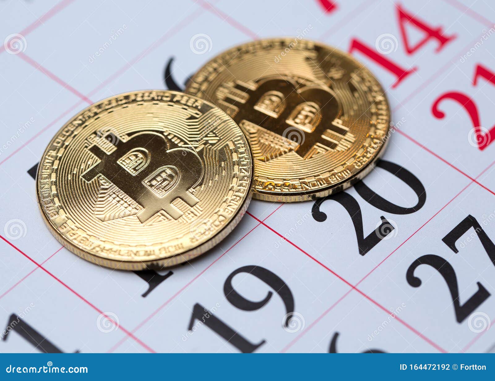 Calendar and Golden Bitcoins Closeup. the Concept of the Date of