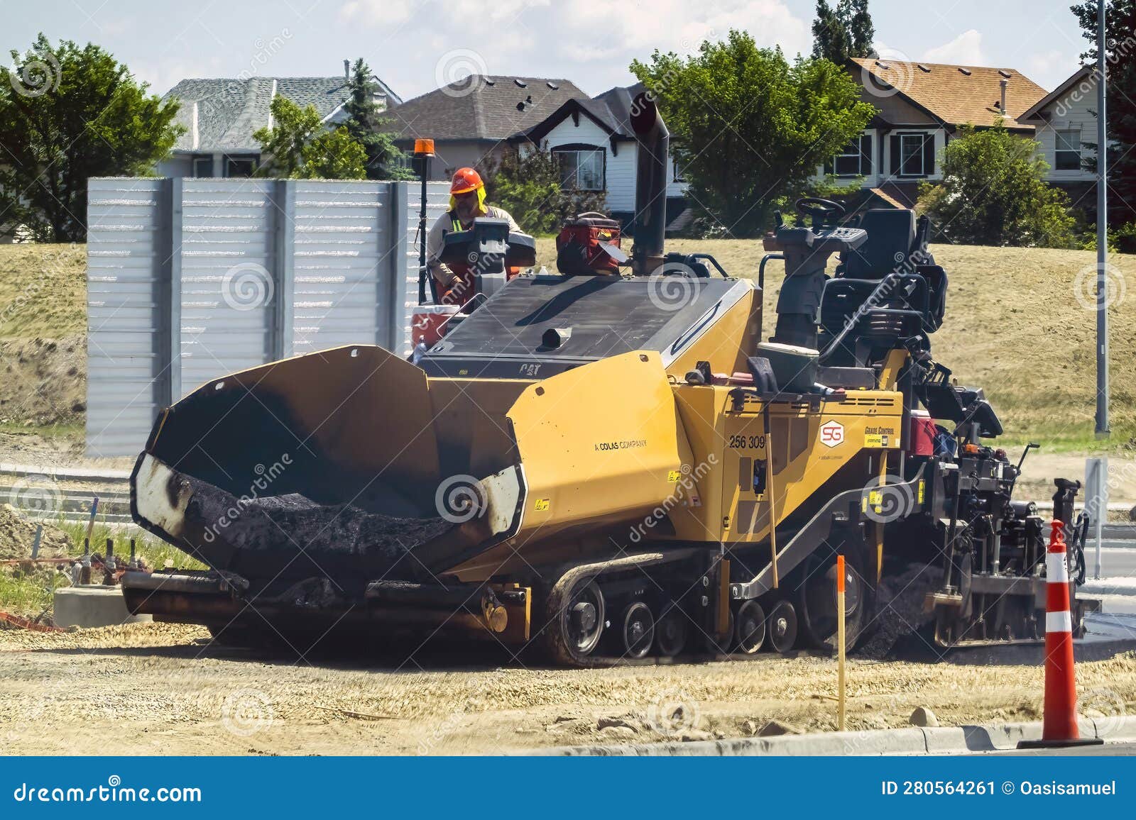 Caterpillar Asphalt Paver on a Work Site during Summer Editorial Photo