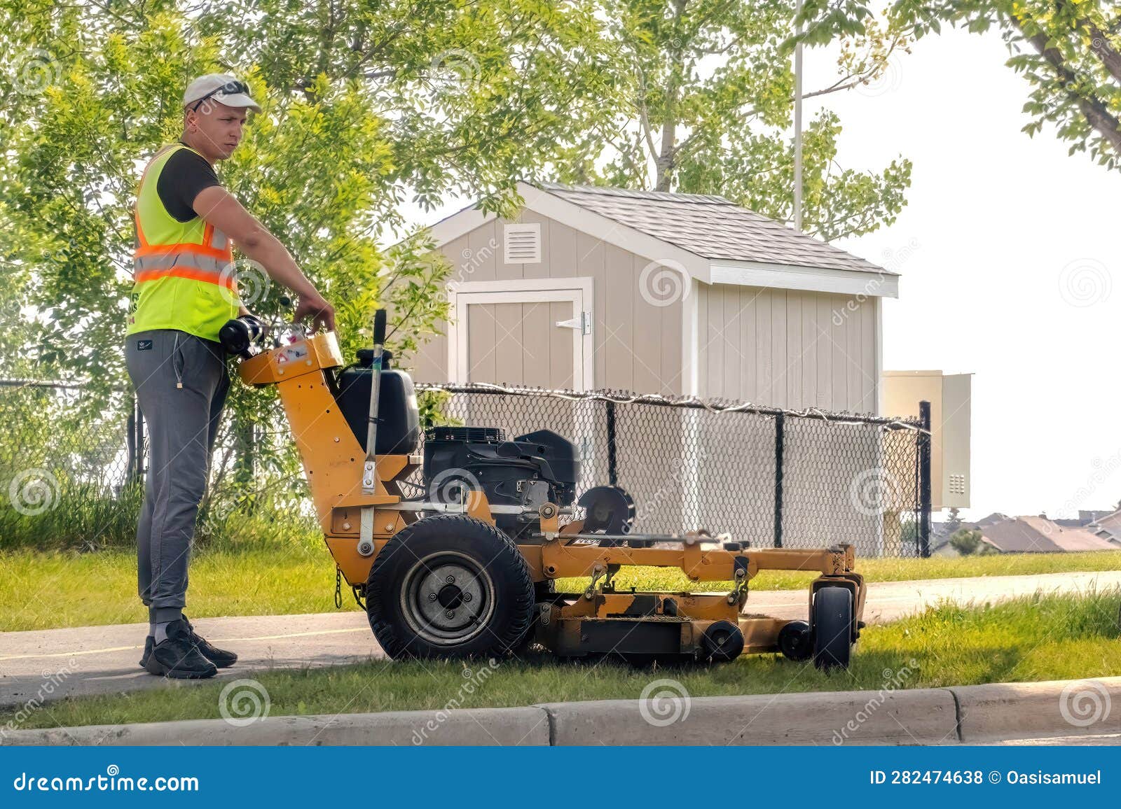 A City of Calgary Landscaping Worker Mowing a Public Space during the