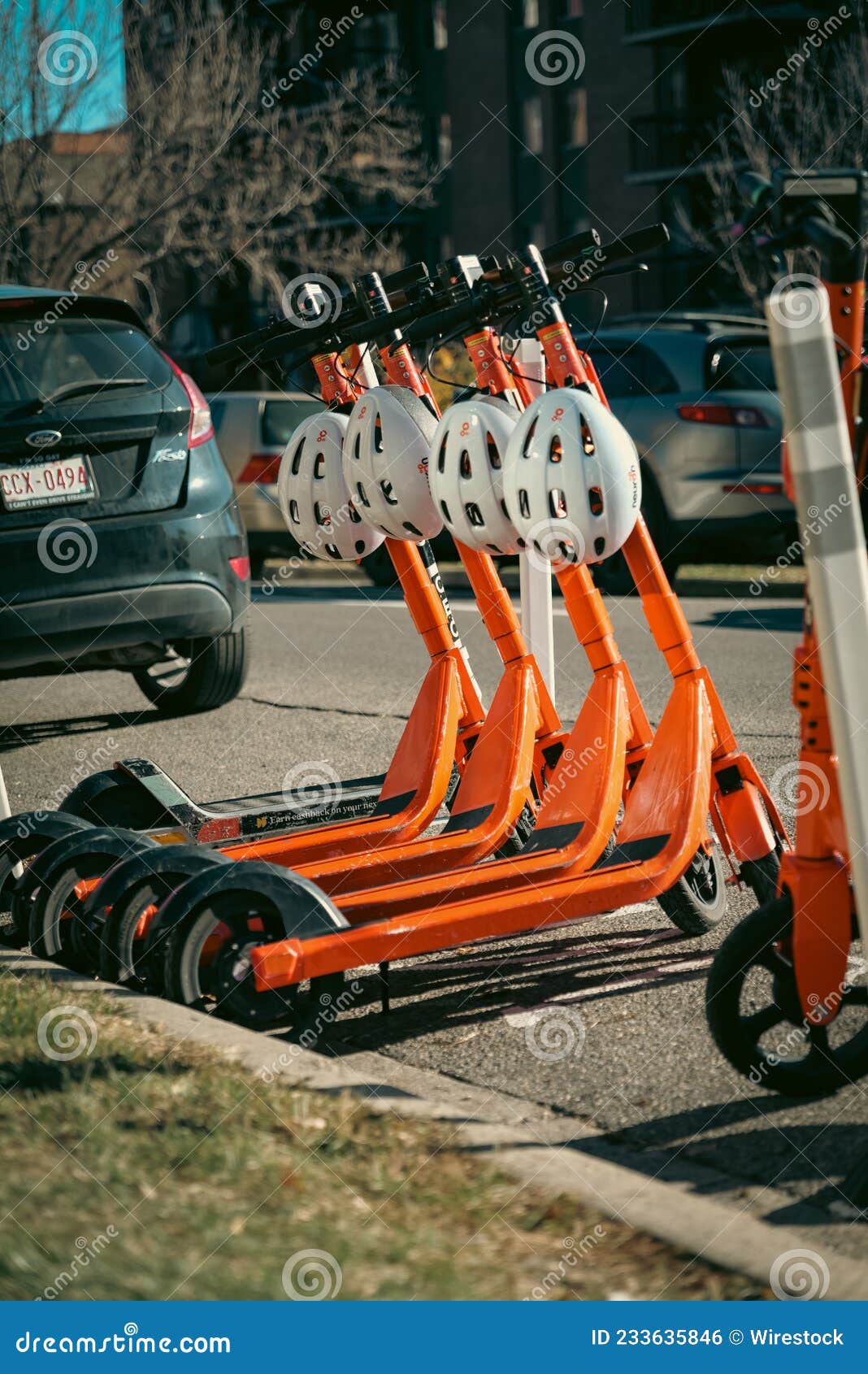 Row Of Orange Scooters For Rent For Youth Public Fun And Transportation
