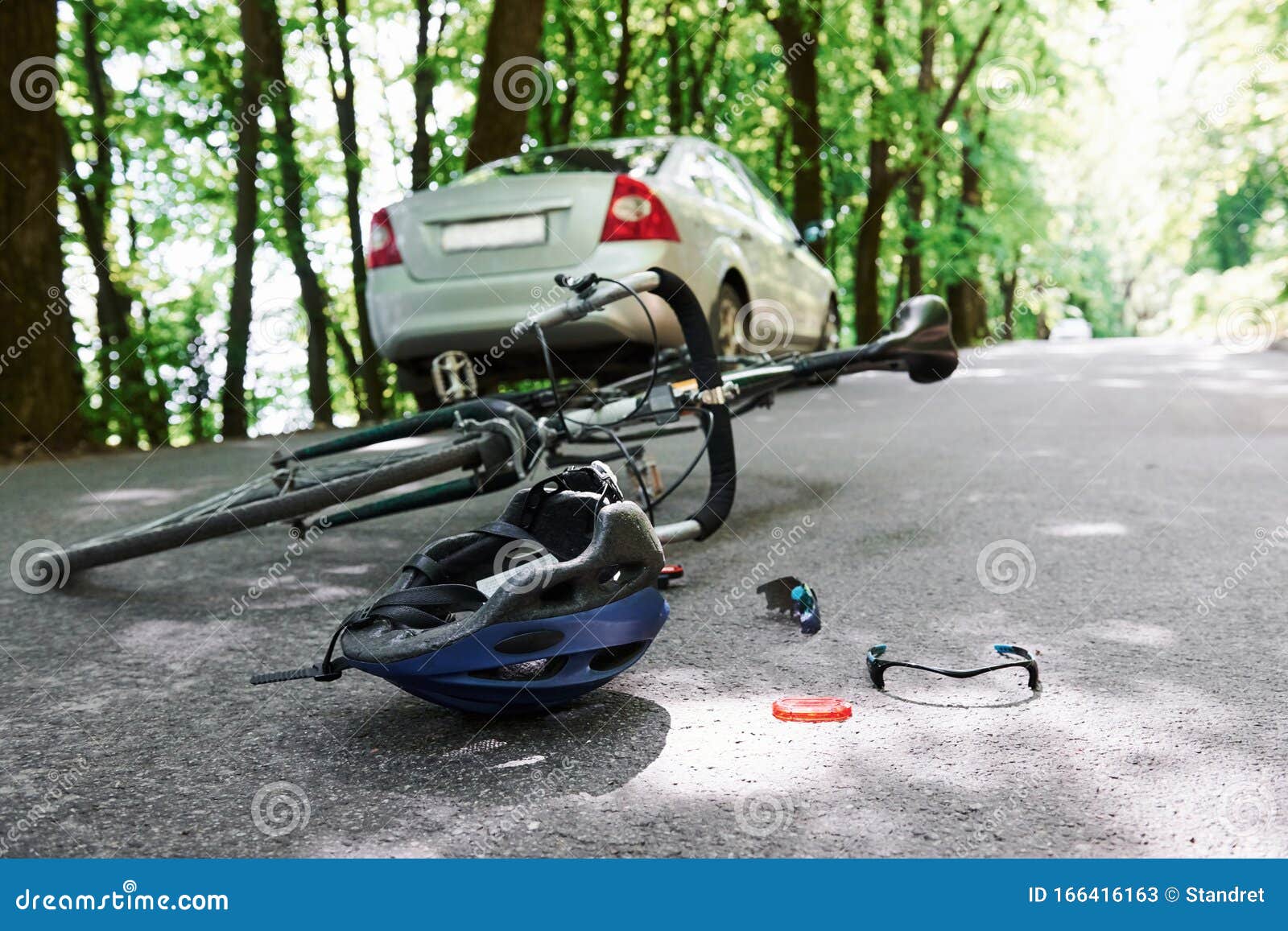 Call an Emergency. Bicycle and Silver Colored Car Accident on the Road