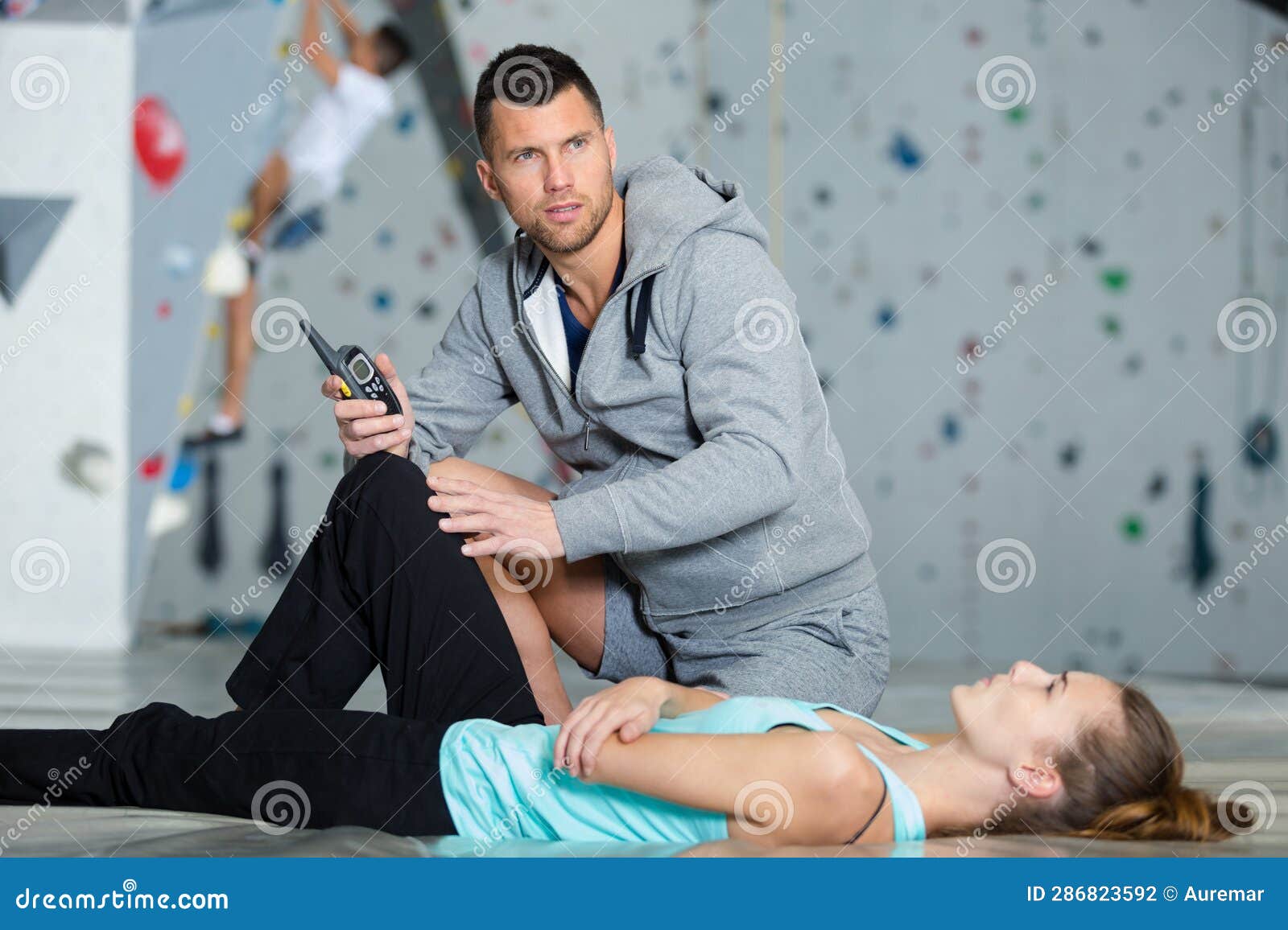 Calling Medical Help during Wall Climbing Accident Stock Photo Image