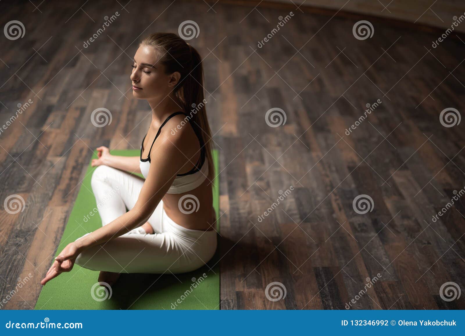 Tranquil Lady Putting Hands on the Knees while Meditating Stock Photo ...